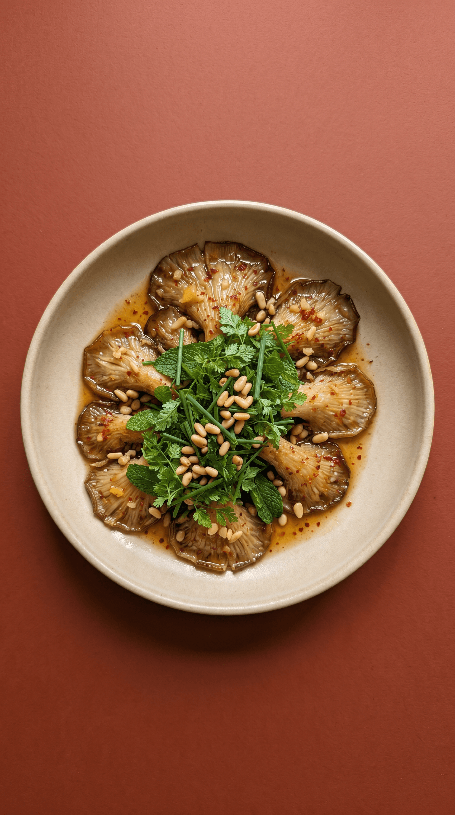 Golden seared oyster mushrooms arranged with herbs, pine nuts and Korean-style sauce